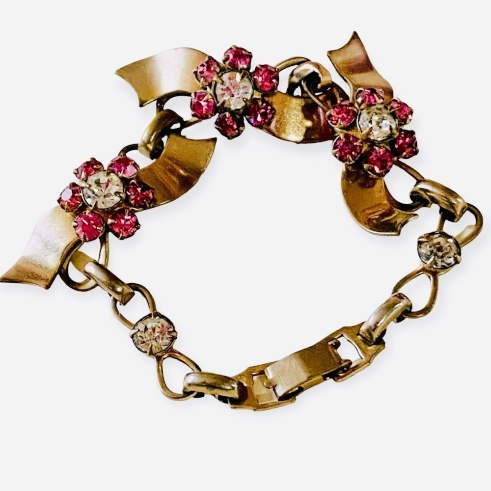 Gold Bow bracelet 6” with garnet and clear color stones set in gold tone 6”